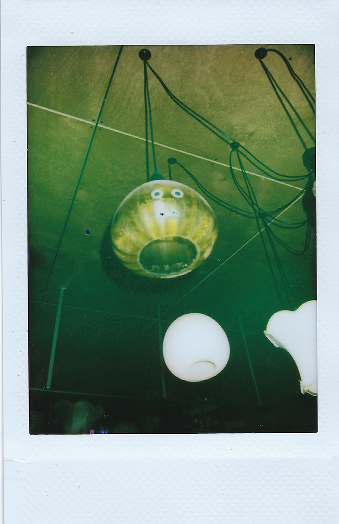 A ceiling lanp with googly eyes on it.