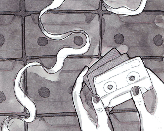 Someone holding a casette tape against a wall of more.